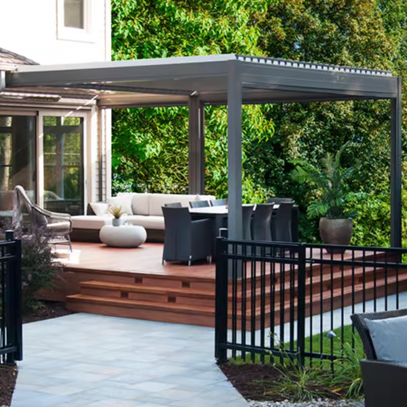 A patio featuring an aluminum pergola and stylish outdoor furniture arranged for relaxation and dining.